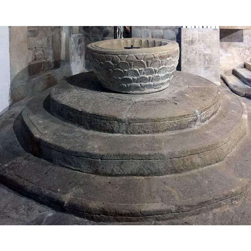 the large font is nonetheless overwhelmed by the sheer size of the massive three-step plinth