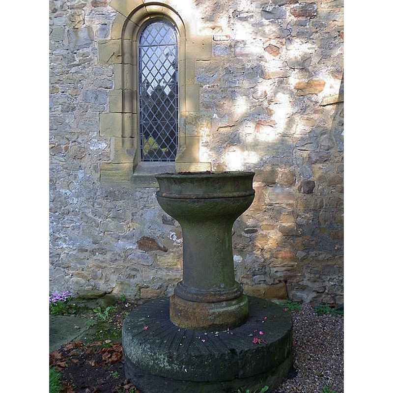 Source caption: "St Radegund's Church. Outside of the church a Georgian font stands near the south porch."