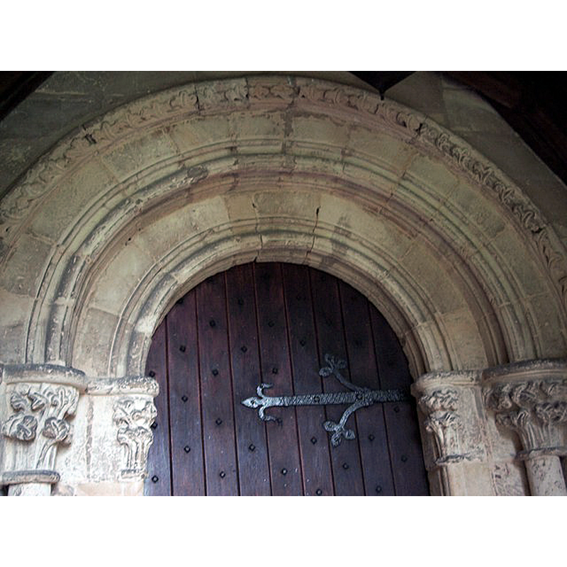 Source caption: "Within the 19th century porch is the elaborately carved 13th century rounded arch of the main south entrance door."