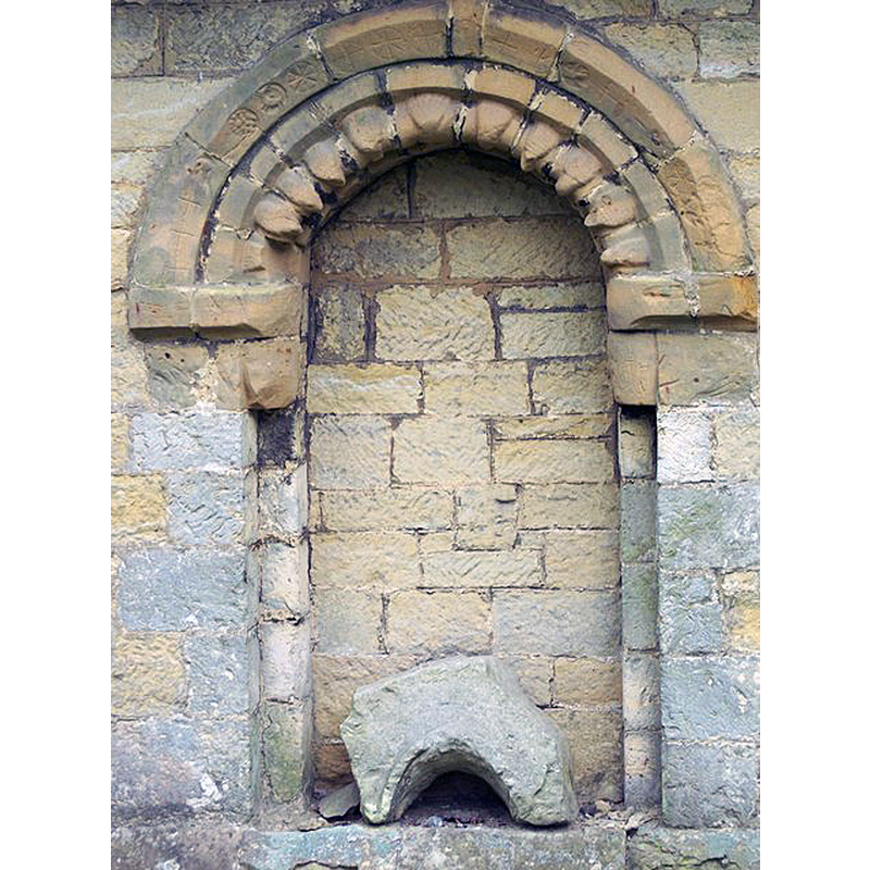 Source caption: "St Hilda's Church, Ampleforth. The present structure is based on the church built in the 12th-13th century with extensive alterations and additions in the 19th century. This is the blocked north door."