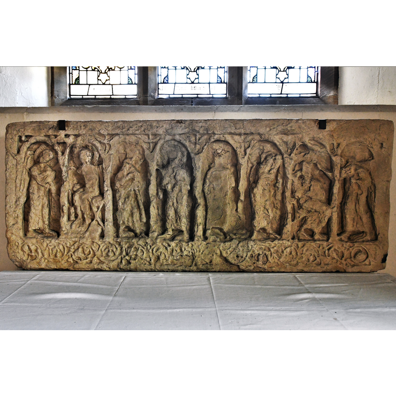 Source caption: "Hovingham, All Saints Church: Fine Saxon carving serving as a reredos in the south chapel" -- the description of this obeject in Great English Churches [www.greatenglishchurches.co.uk/html/hovingham.html] [accessed 2 December 2019] reads: "Eight figures are set within round topped panels. The outer figures are angels (the left hand figure is the best-preserved) and they look inwards. The second figure from the left is clearly seated. The Church Guide says these two left hand figures constitute the Annunciation by the Archangel Gabriel to Mary the Virgin of the forthcoming birth of Jesus. The figures in the other panels cannot be identified due to weathering. Above each intersection of the panels is a dove. The lower decoration is of entwined birds and vine leaves."