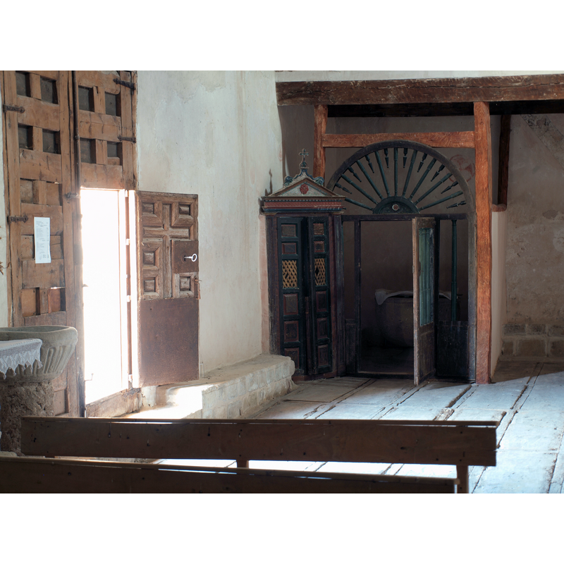 on the left, by the south doorway is the holy-water stoup -- at the back, in the southwest corner of the nave is the enclosure fashioned as baptistery and housing the font