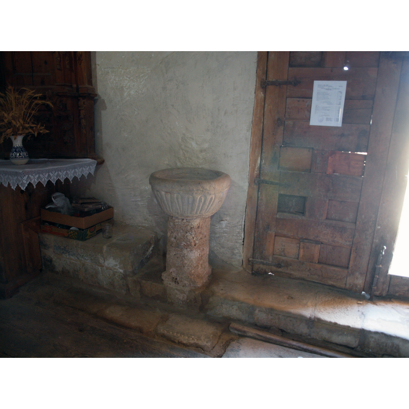 the pedestal holy-water stoup by the south entranceway