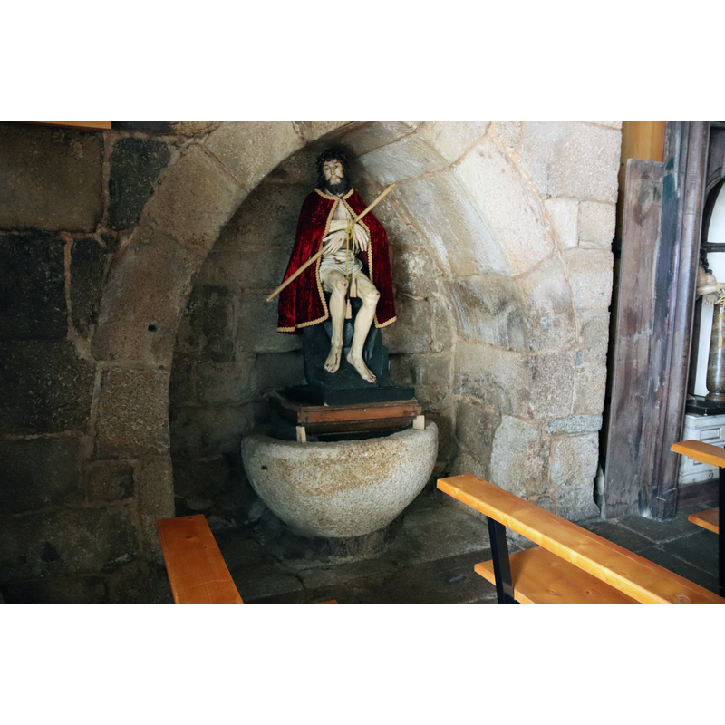 in an alcove of the north wall of the nave, just west of the north entranceway -- perhaps this font is now disused as it appears to serve as the base for the Ecce Homo on it