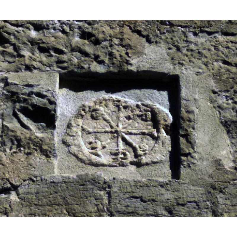 originally found built into the north wall; restored and installed above the south portal; said to be late-12thC [https://museodiocesano.es/2012/03/22/un-nuevo-crismon-trinitario-en-la-diocesis/] [accessed 18 December 2019]