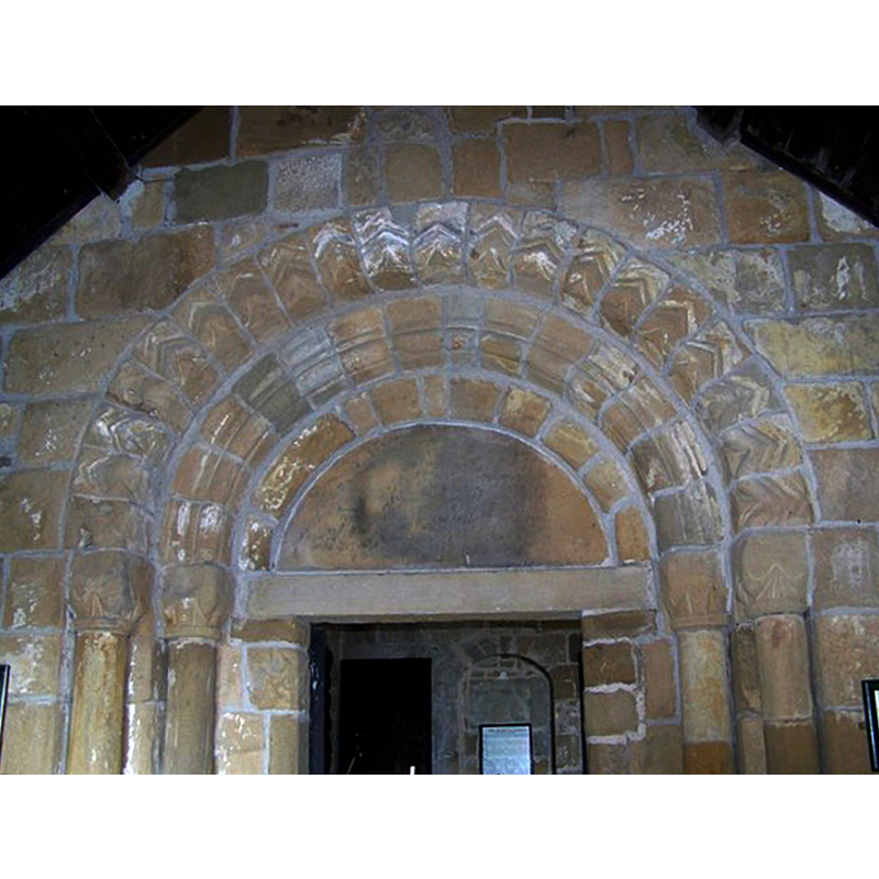 Source caption: "Doorway arch, All Saints Church, Great Ayton The doorway arch has chevron mouldings characteristic of the Norman style."