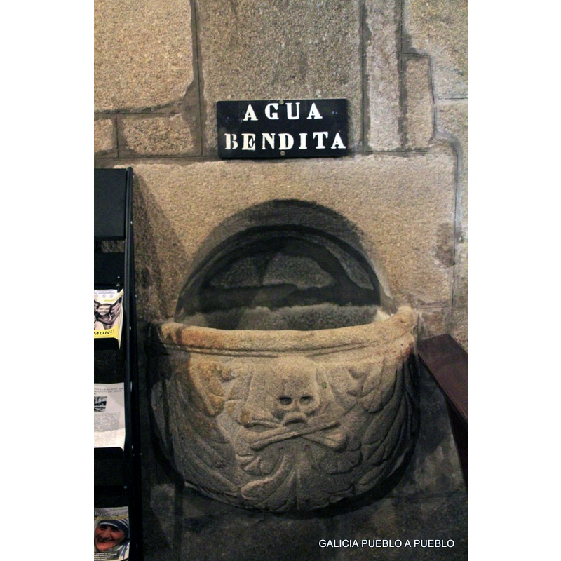 the wall-mounted stoup, said to be a re-used 19thC font [cf. FontNotes]