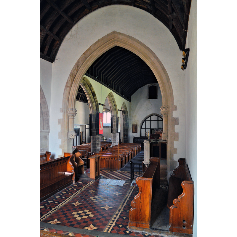 Source caption: "St Paulinus, Llangors. The nave, seen through Thomas Nicholson's chancel arch of 1873-5. The fine tiled floor by Godwin of Lugwardine is of a similar date. "