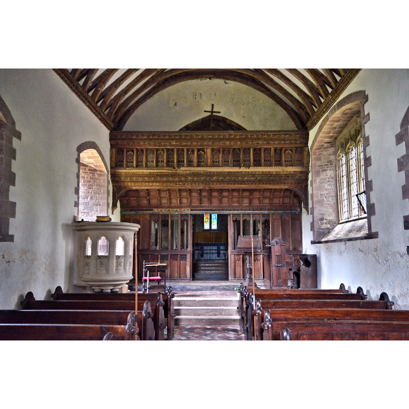 Source caption: "St Jerome, Llangwm Uchaf. No longer in use and in the care of the Friends of Friendless Churches, St Jerome's is at the end of a winding lane and would be impossible to find without the helpful sign on the B4235. The glory of the place is the fantastic screen of around 1500, complete with loft. Repaired tactfully by J.P. Seddon during his 'restoration' of 1863-9, it is an incredible survival. The less than tactful pulpit is by Seddon."