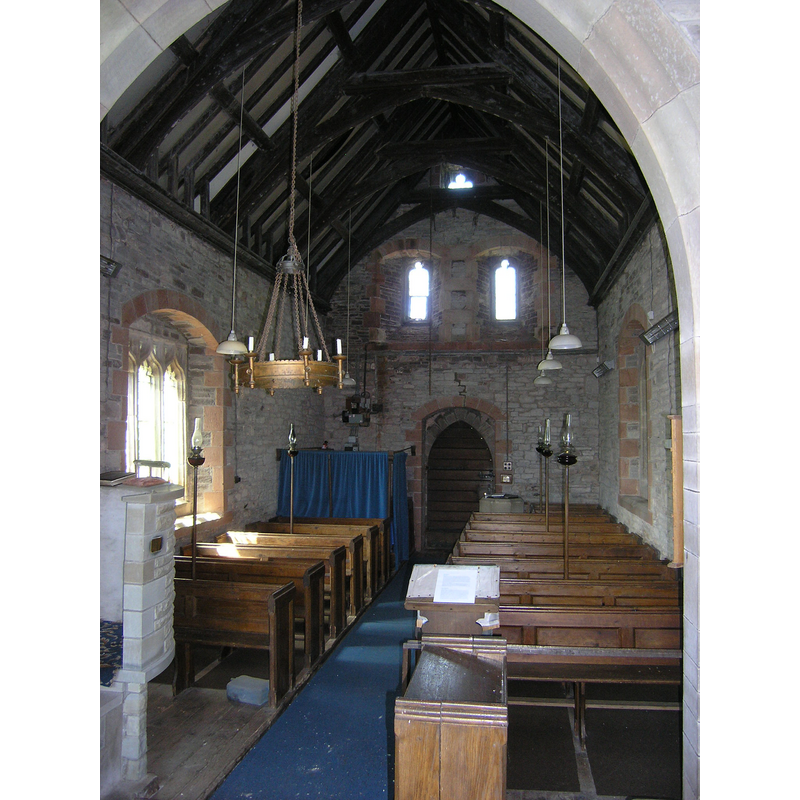 Source caption: "St John, Llangwm Isaf. Still in use, this tiny church has a medieval origin but was rebuilt from ruins by John Prichard 1849-51."