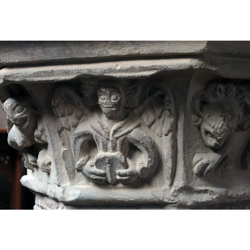 seen here in the centre panel, with wild hair and open wings