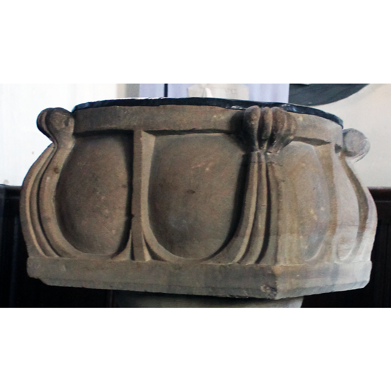 at the angles, with the curl at the upper rim, forming the frame for the basin