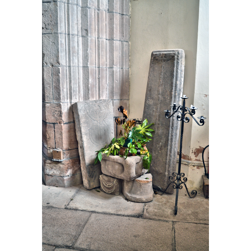 Source caption: "St Nicholas, Trellech. Coffin lids and sundry bits of ancient carved stone under the tower."