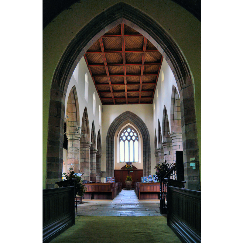view from the east side of the chancel arch -- the font is visible at the far end of the centre aisle