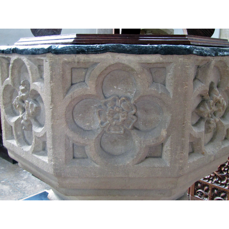 the panels appear to alternate between the rose and a cross-shaped flower, except the west side, which is blank