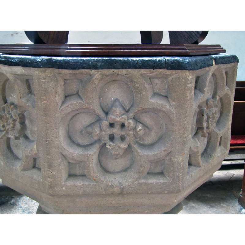 the panels appear to alternate between the rose and a cross-shaped flower, except the west side, which is blank