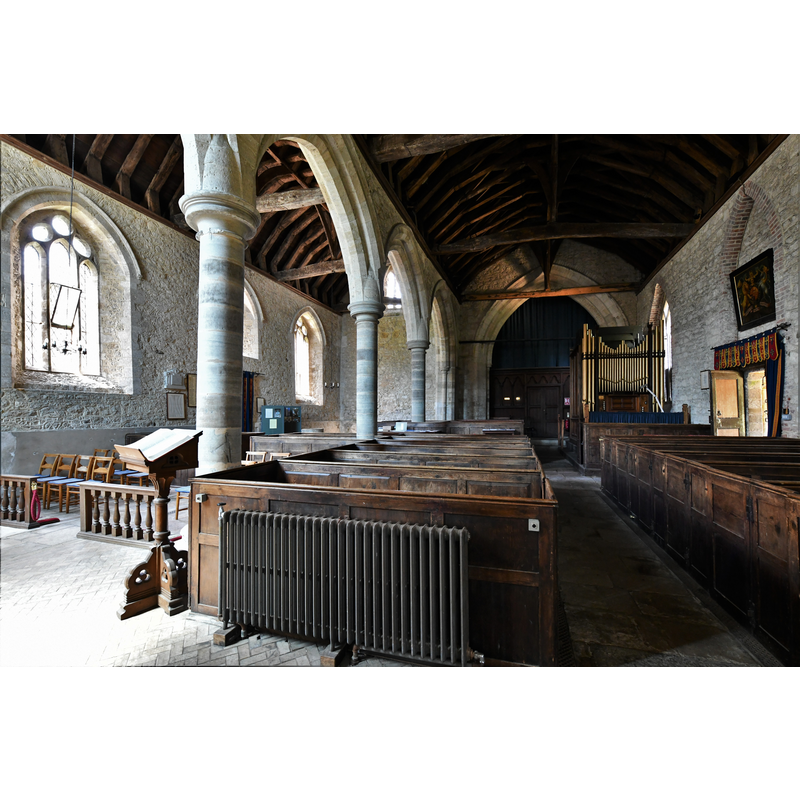 only the upper rim of the font is visible here, at the west end of the south aisle, by the green/teal cabinet next to the south entranceway