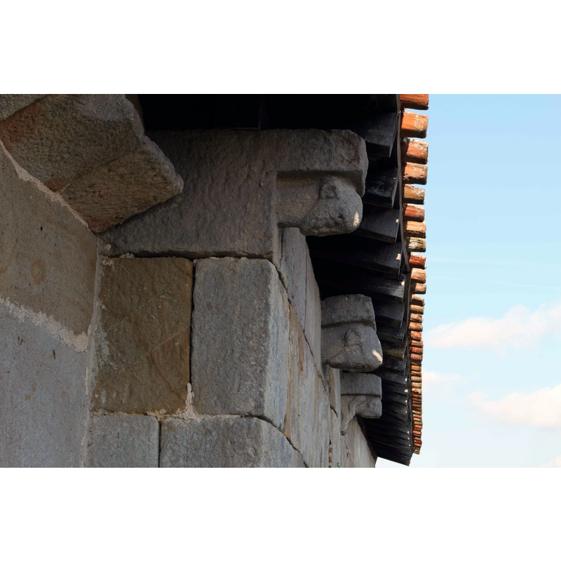 visible here are three of the early corbels, perhaps from the original pre- or early-Romanesque church here [cf. FontNotes]