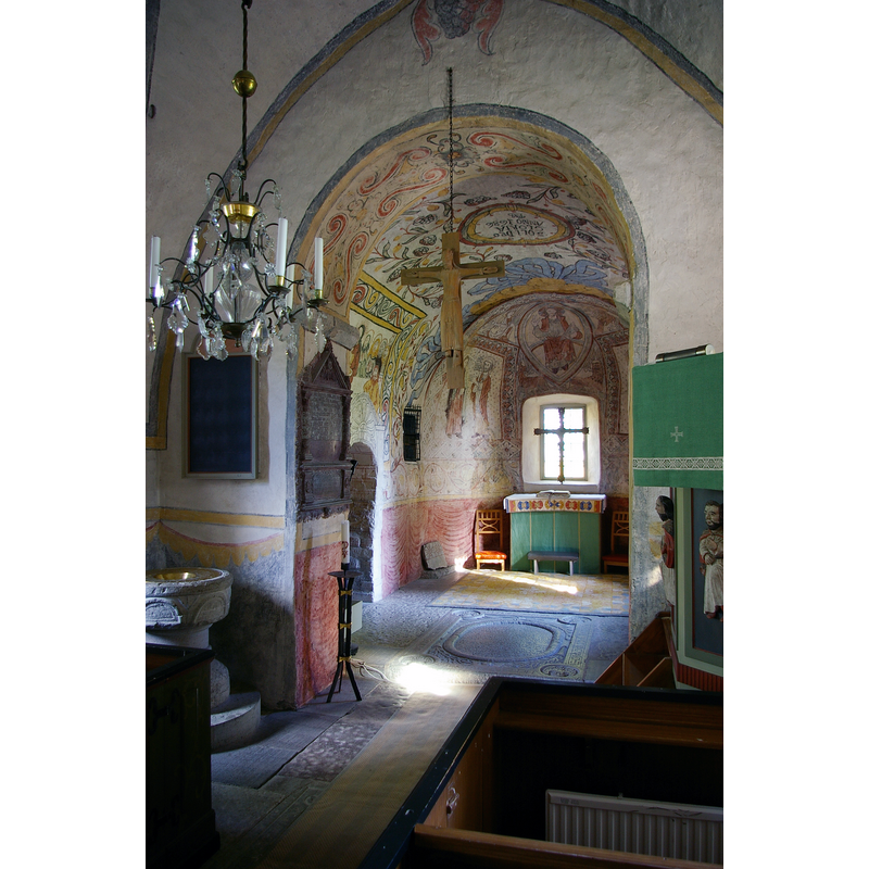 the medieval font located on the east side of the north pillar of the chancel arch