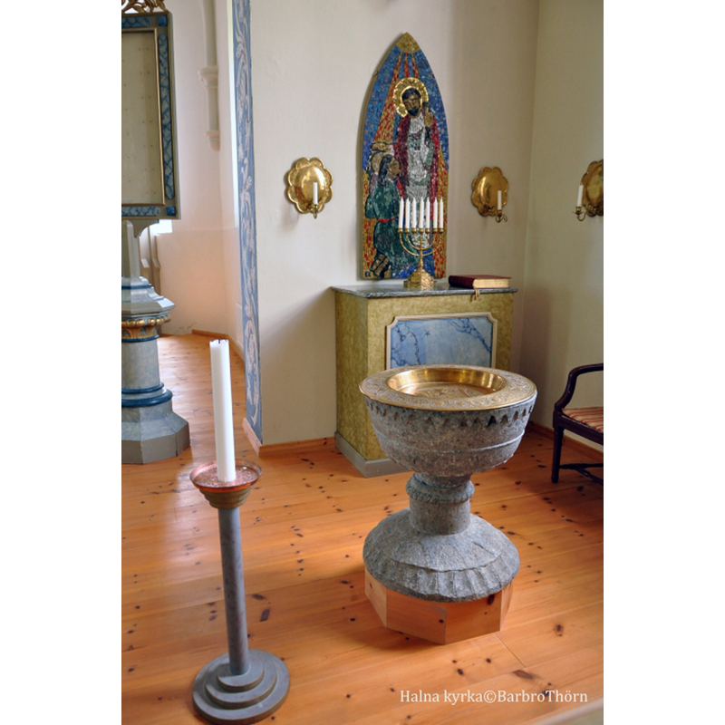 the medieval font now in the new church, raised on a wooden plinth to give it a functional height