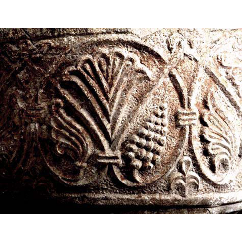 a very intricate pattern in the shape of an acanthus vine with palmette leaves and bearing fruit