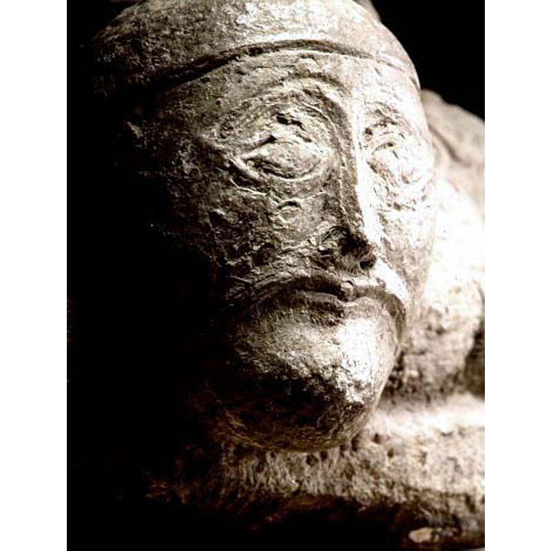 unlike the other three heads this one has fairly regular features: a male head with moustache and beard; it appears to wear an undecorated helmet