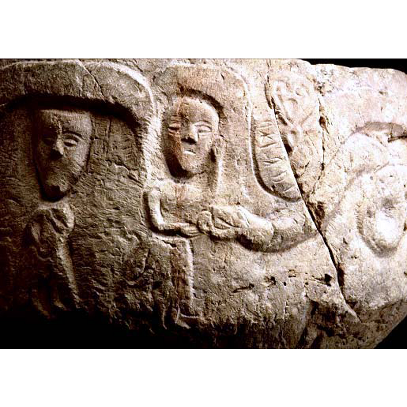 Adam seen here beneath the arch-head; Eve takes the apple from the serpent's mouth; above the serpent's neck is a bubble-like shape containing a Runic inscription [no transcription available] and a head-shaped foliage motif; the large coil in the serpent's body occupies the next arch-head to the right
