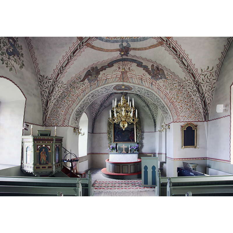 the 19thC wooden font is partially visible in the southeast corner of the nave, beneath the psalm board