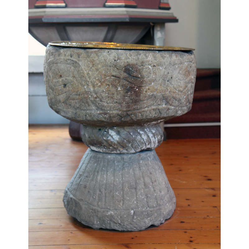 the medieval font in the modern church