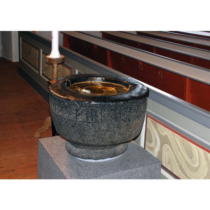 the medieval basin as displayed in the new church, on loan from the museum