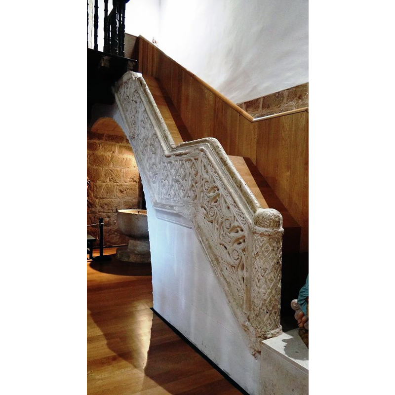 semi-hidden beneath stairs leading up to the west gallery