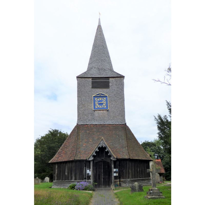 Source caption: "St Mary the Virgin at High Halden. Front view from the road showing the wooden spire and the wooden smock-like base."