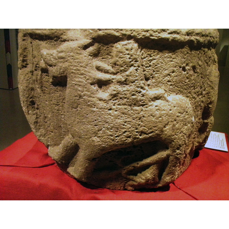 the lion's identity confirmed by the foliated long tail visible by its hind leggs; the human rider extends his(?) arms to hold the beast's neck