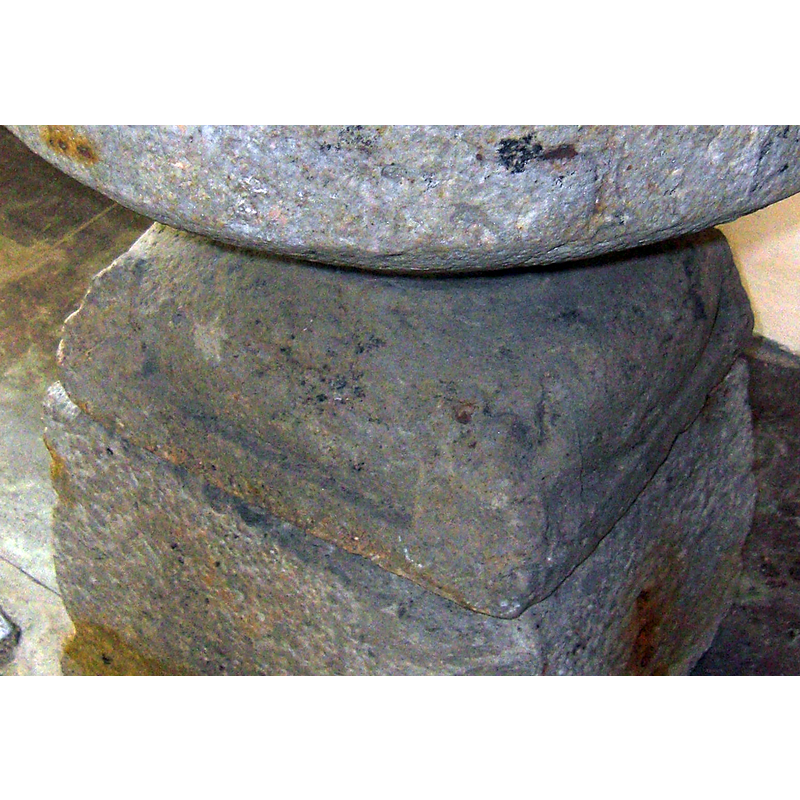 at the angles of the base, too eroded for certainty -- the one on the left appears to have been a human head