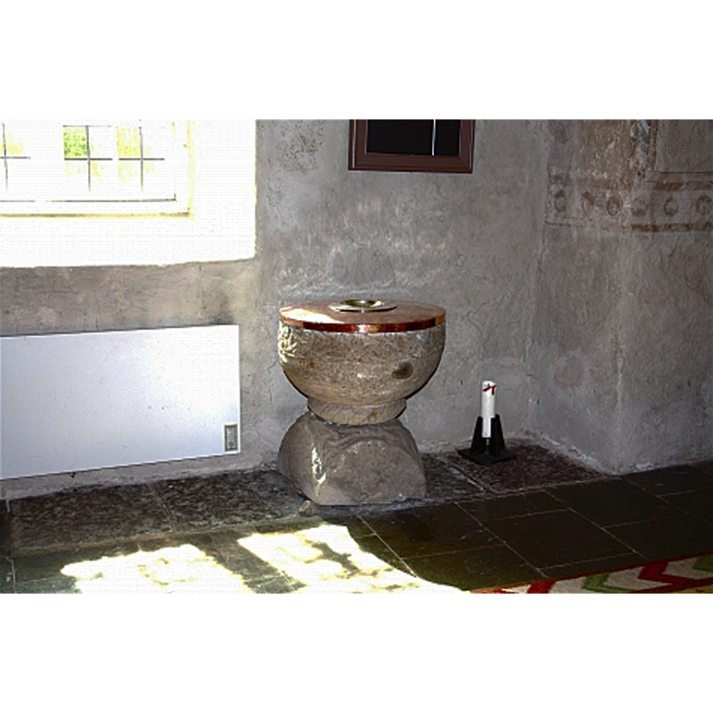 the font at the east end of the nave, against the south wall