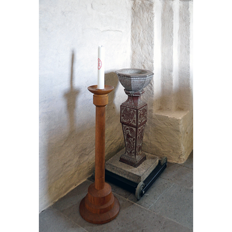 the later font in this church, made by Johan Andersson of Vadstena in 1665 -- notice the little trolley with wheels that allows for the font to be moved around the church interior