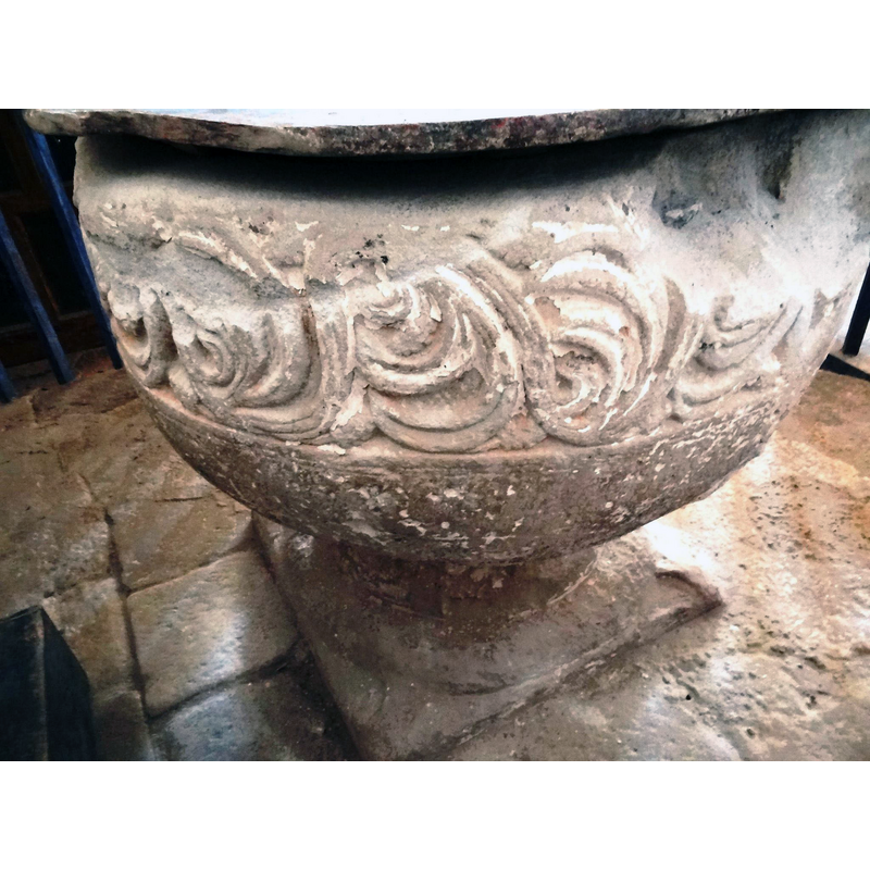 notice on the upper-right corner of the image the large damage to the upper rim area where a metal anchoring for an old cover split the stone