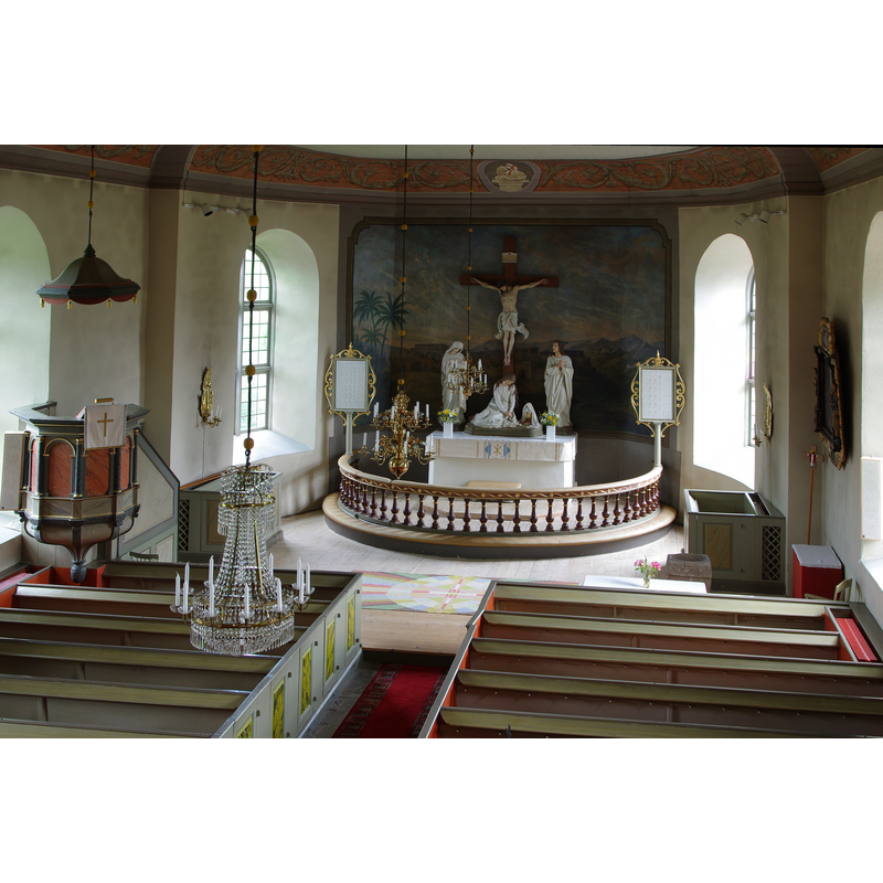 the square font originally from Härlunda kyrka is partially visible at the far [east] end, [right] south side