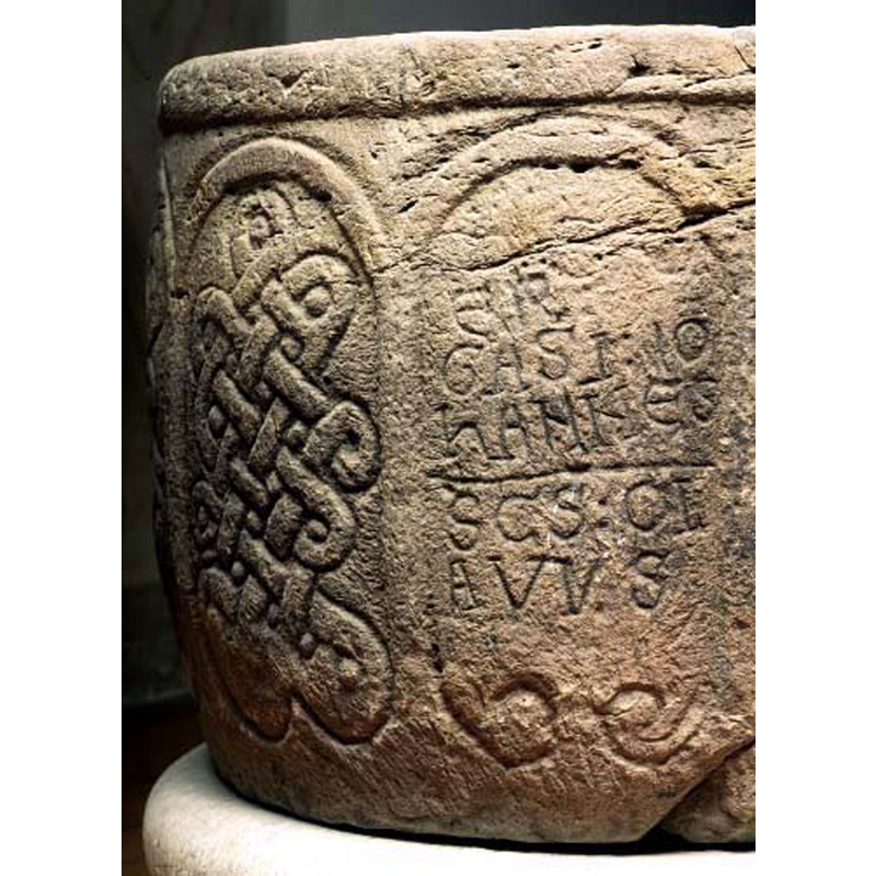 an intricate one seen here to the left of the inscription