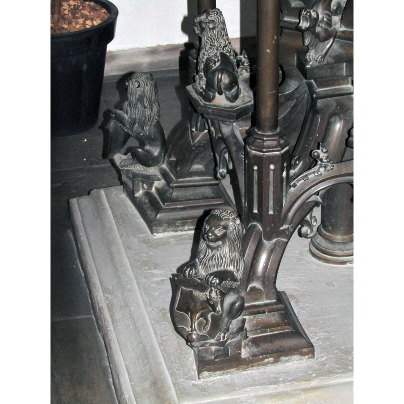 at 90-degree angles on the lower base -- the emblem on each shield appears to relate to one of the Evangelists