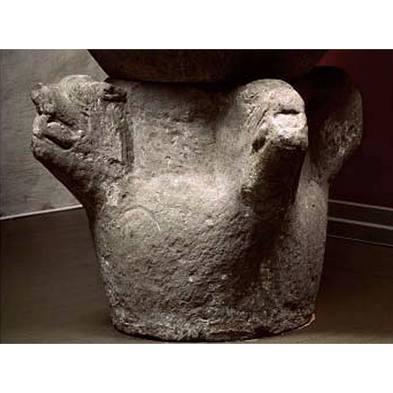 though this base was much re-cut to serve as the basis of a dial, the four characteristic animal heads can still be discerned; there probably were carvings or paintings in the areas between the heads originally