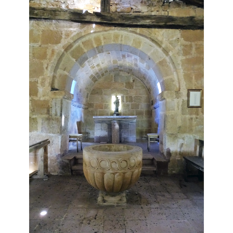 with the font at the east end of the nave, west of the chancel arch