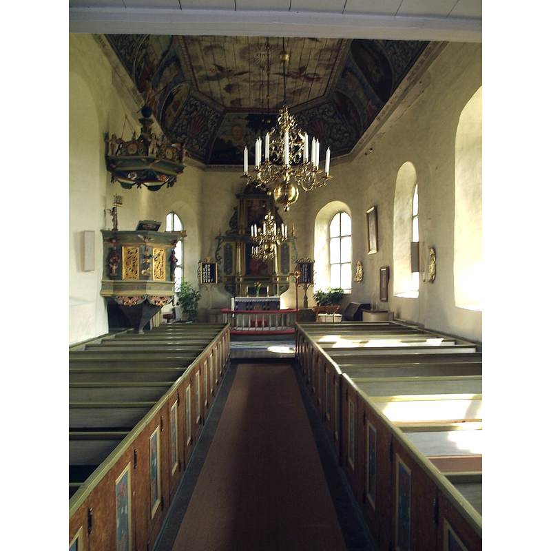 the old font is partially visible at the far [east] end, south [right] side, in front of the right side pews