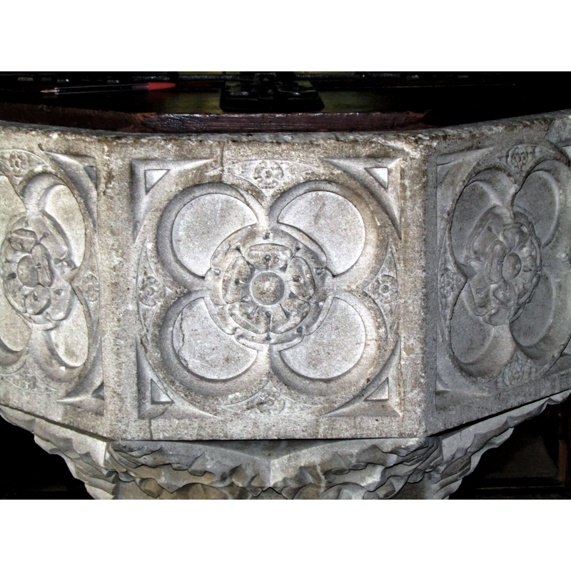 large floral symbols that have other tiny ones in the spandrels of the quatrefoils