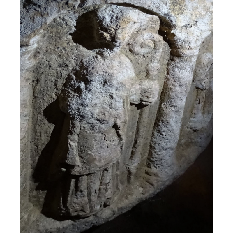 most of the features have been defaced or eroded, but the clerical garb, the hand and the staff are clearly discernible