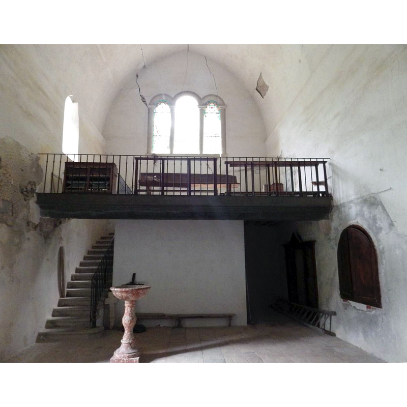 the west gallery in the centre and its stairs on the left [south] side; the large wooden doors at the back on the right [north] side belong to the confessional; the window-like shutters hide the embedded baptismal font