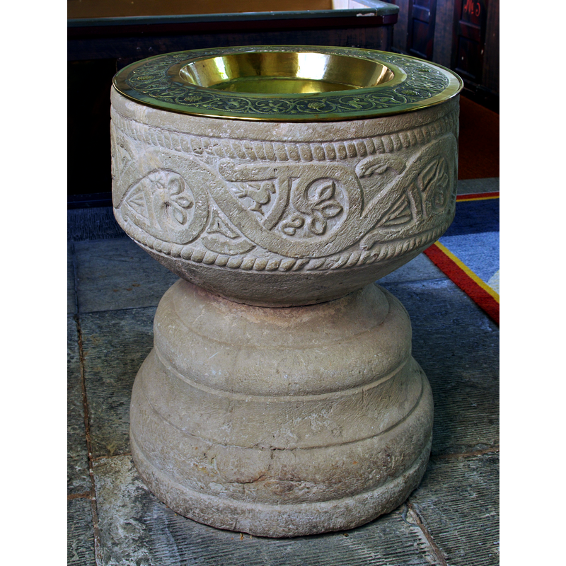 the medieval font, now free-standing and returned to its original function