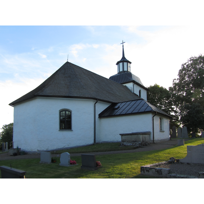 Source caption: "Odensåkers kyrka och kyrkogård. Kyrkan och kyrkogården ligger väster om sjön Östen i södra Vadsbo härad i nordöstra Västergötland"