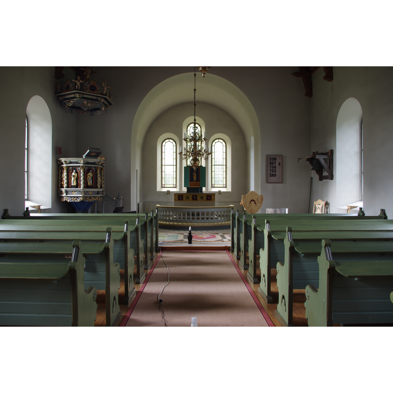the top of the medieval font can be seen here, at the far [east] end of the nave of the new church, tight [south] side -- Source caption: "Suntaks nya kyrka i Tidaholms kommun (Skara stift)."