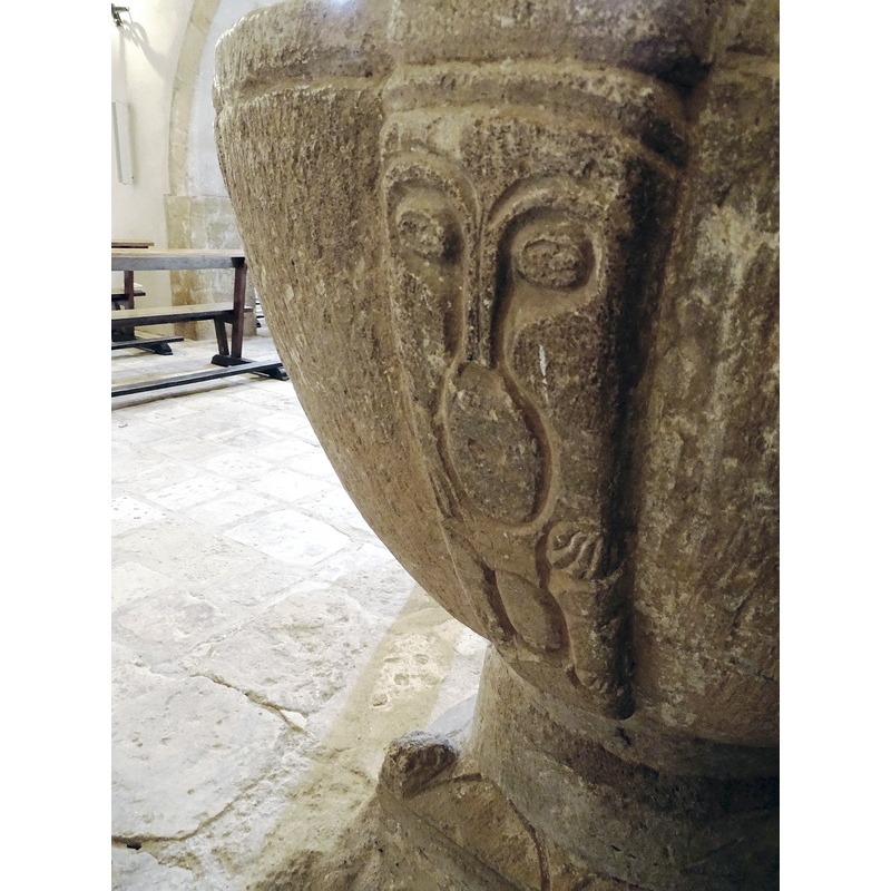 a humanoid shape carved on  one of the squarish ribs; could be a full figure